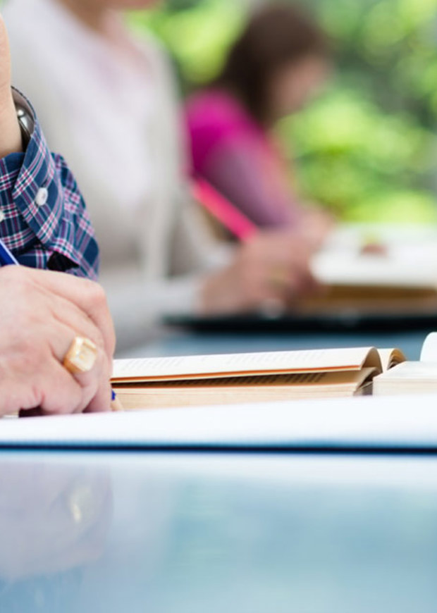 Person writing at a table