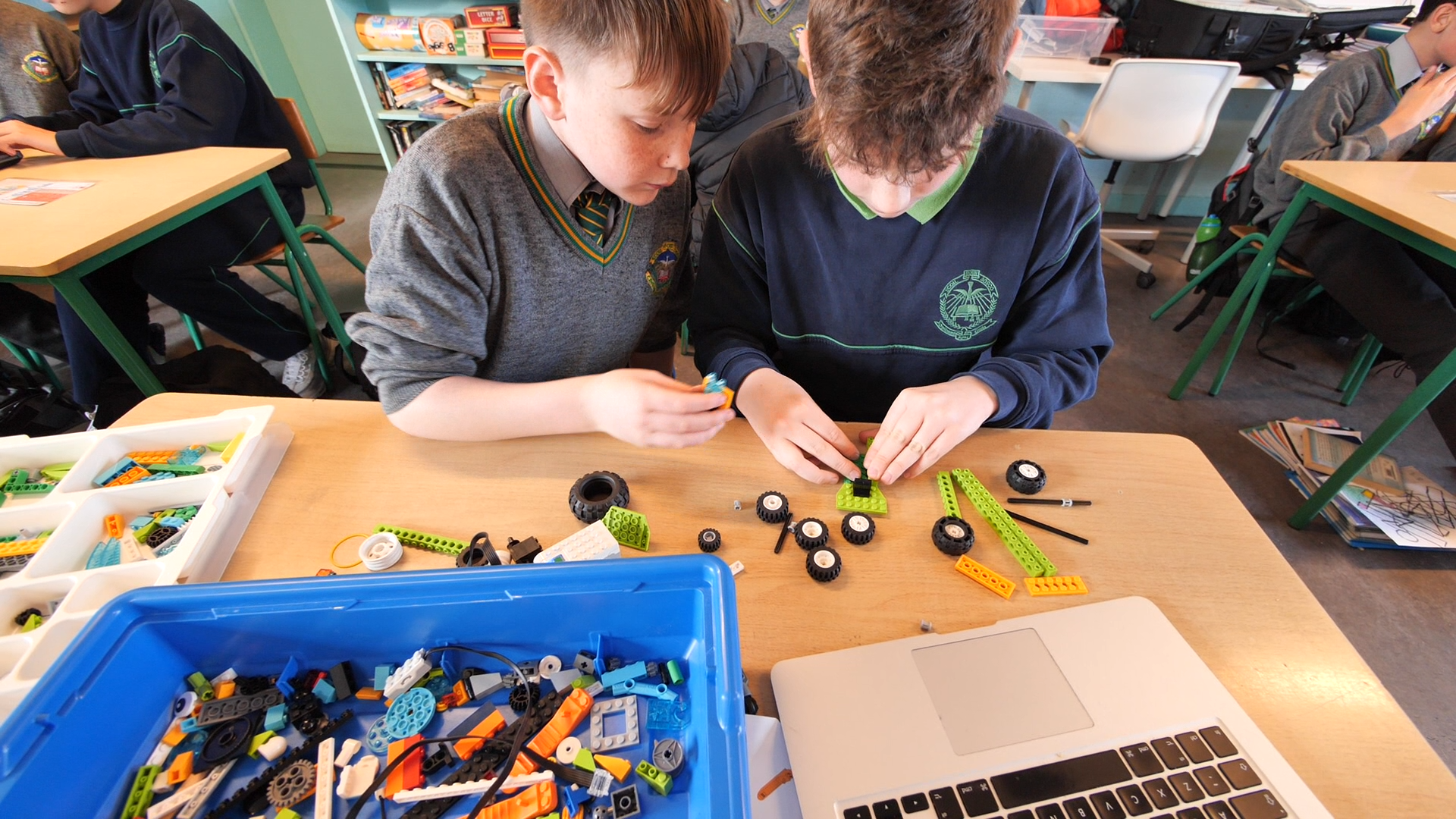 Two children building with Lego