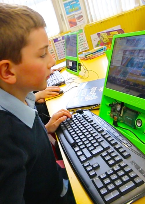 Child working on a computer in class