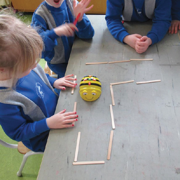 Children working with Beebots