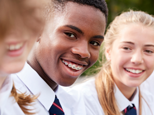 Three students smiling outside