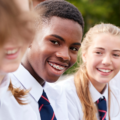 Three students smiling outside